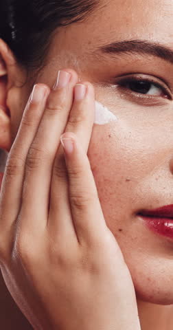 Skincare, face of woman and apply sunscreen for wellness, self care and spf protection for health. Portrait, dermatology and person with cream for grooming routine, closeup or lotion for glowing skin