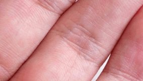 Extreme close up macro shot of human skin texture. The detailed view shows the lines, wrinkles, and ridges of a person's hand or fingers. - Powered by Shutterstock - Get 15% off with code: PIKWIZARD15