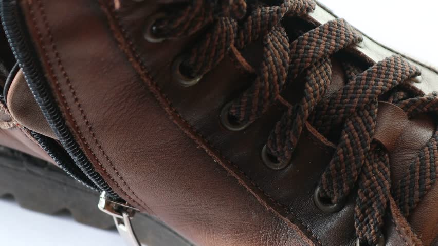 A detailed view of a pair of brown shoes.
