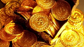 A treasure chest overflows with shiny gold coins in a top down view. The camera rotates, revealing a pile of golden riches with dollar signs. - Powered by Shutterstock - Get 15% off with code: PIKWIZARD15