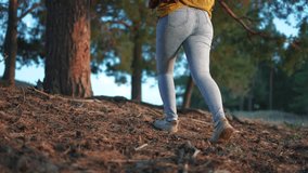 Girl tourist with a backpack walks through the forest. The concept of traveling the lifestyle of people and nature. Female tourist walks through forest. Girl with backpack forest walking through the. - Powered by Shutterstock - Get 15% off with code: PIKWIZARD15