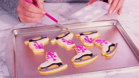 Decorating figure skate-shaped sugar cookies with colorful royal icing. Perfect for festive baking, winter-themed treats, and creative dessert visuals. - Powered by Shutterstock - Get 15% off with code: PIKWIZARD15