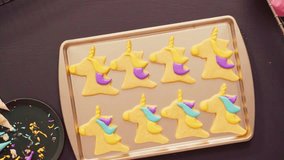 Decorating unicorn-shaped sugar cookies with vibrant multi-color royal icing. Fun and creative baking activity perfect for parties, holidays, and whimsical dessert visuals. - Powered by Shutterstock - Get 15% off with code: PIKWIZARD15