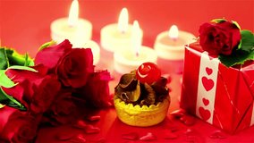 Romantic Valentine’s Day composition featuring a chocolate cupcake, red roses, and a wrapped gift. Sweet and elegant love concept symbolizing affection, celebration,  romance, ideal for Valentine day - Powered by Shutterstock - Get 15% off with code: PIKWIZARD15
