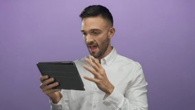 Young hispanic man expresses triumph while using tablet against vibrant purple background in modern setting showcasing emotions and technology interaction. - Powered by Shutterstock - Get 15% off with code: PIKWIZARD15