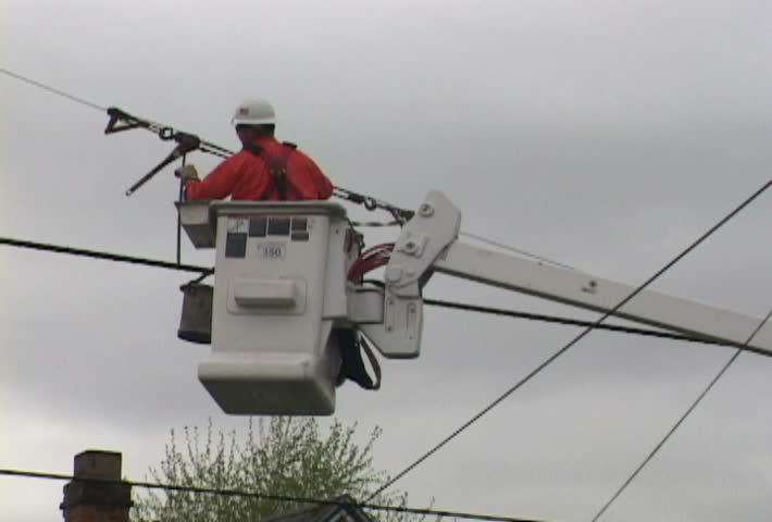 Man from power company repairing power line in clip series.
