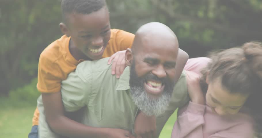 Dad lifting kids climbing onto back for family marketing as sparkles drifting adults joining behind. Family, outdoor, playful, bonding, celebration, joyful, nature