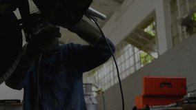 Mechanic raising torch under car lift, sparks flying while code expanding over worker showing data. Industrial, workshop, technology, automation, engineering, machinery, professionalism - Powered by Shutterstock - Get 15% off with code: PIKWIZARD15