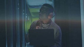 IT technician glancing at rack in server aisle and tapping holographic diagnostics panels fading in. Technology, innovation, futuristic, cybersecurity, data, analytics, interface - Powered by Shutterstock - Get 15% off with code: PIKWIZARD15