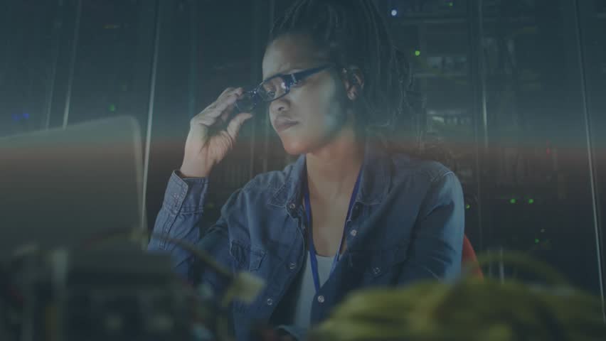 Female IT engineer raising AR viewer, displaying data holograms for monitoring server metrics. Technology, innovation, futuristic, digital, connectivity, cybersecurity, data - Powered by Shutterstock - Get 15% off with code: PIKWIZARD15