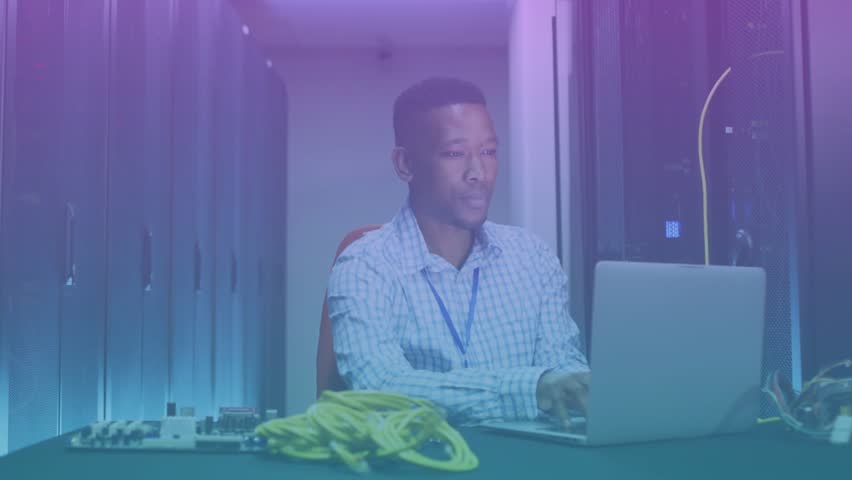 Man sitting at data center desk using laptop while processing data overlay reaching 100% fading. Technology, data center, cybersecurity, connectivity, network infrastructure, digital transformation - Powered by Shutterstock - Get 15% off with code: PIKWIZARD15