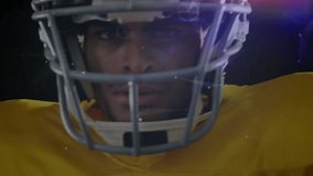 Football player staring into camera starting halo of particles around helmet showcasing sports tech. Athlete, digital, futuristic, innovation, technology, energy, motion - Powered by Shutterstock - Get 15% off with code: PIKWIZARD15