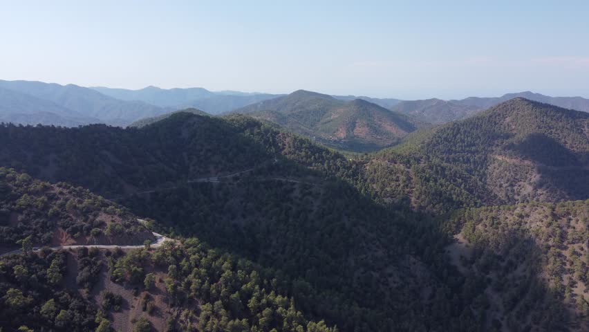 Drone flight over the Troodos Mountains in Cyprus showing scenic mountain landscape and forests