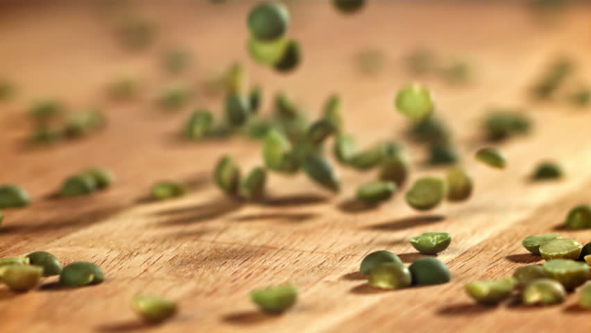 Green peas fall on the table. Filmed on a high-speed camera at 1000 fps. High quality FullHD footage