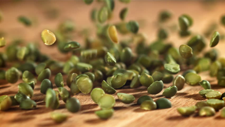 Green peas fall on the table. Filmed on a high-speed camera at 1000 fps. High quality FullHD footage