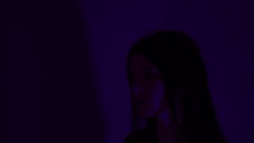 Caucasian woman wearing cyber glasses with red lights. With glitch noise on video. Dark background. - Powered by Shutterstock - Get 15% off with code: PIKWIZARD15