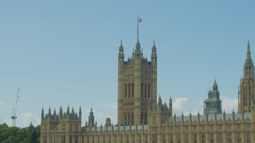 Close-up view of the Palace of Westminster under a bright blue sky on a sunny day in London, England. View of the Palace of Westminster across the River Thames on a clear day