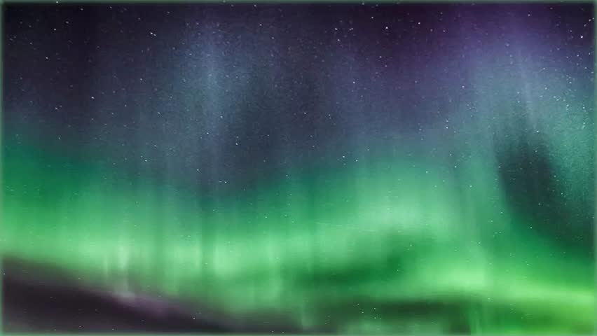 Vibrant green northern lights shimmering across dark night sky with visible stars. 
