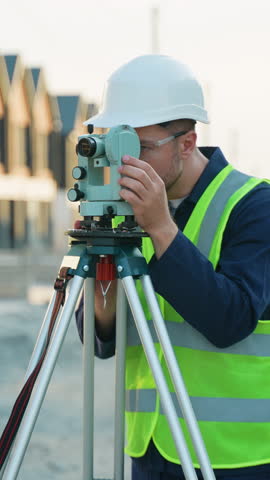 Surveyor engineer using theodolite measuring on construction site