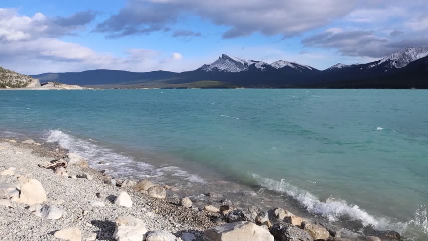Turquoise Mountain Lake with Snow-Capped Peaks in Canada