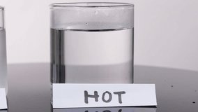 Blue and yellow dye disperses rapidly in hot water glass under bright, even studio lighting - Powered by Shutterstock - Get 15% off with code: PIKWIZARD15