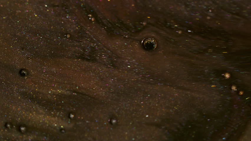 Shimmer spill. Paint water. Defocused yellow golden purple color bubble oil acrylic liquid floating on abstract art bokeh background.