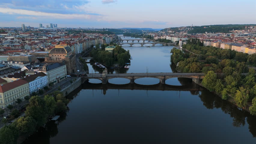 Breathtaking drone footage beautifully captures mesmerizing charm of Prague, perfectly showcasing its iconic historic bridges and enchanting riverside scenery that mesmerizes viewers, Czech Republic