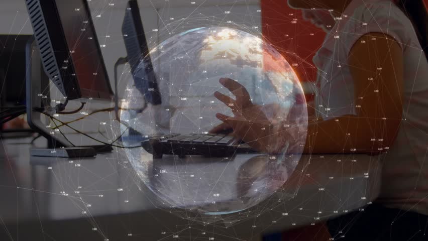 Boy leaning forward at school computer showing globe overlay while typing and exploring data. Children, digital, technology, education, innovation, concentration, networking - Powered by Shutterstock - Get 15% off with code: PIKWIZARD15