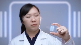 Asian Scientist Analyzing Miniature DNA Hologram Chip, Representing Future Biotechnology, Genetic Research, and Precision Medicine Innovation. - Powered by Shutterstock - Get 15% off with code: PIKWIZARD15