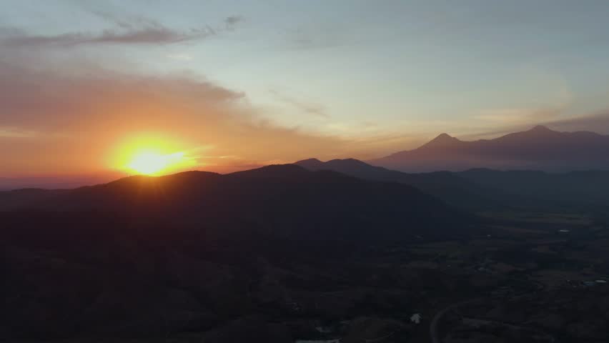 Sunset over Route 110 near Tecalitlán with Colima and Nevado de Colima volcanoes