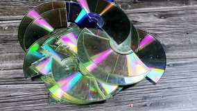 Several broken compact discs CDs that display a rainbow-like effect known as iridescence, a CD is digital optical disc data storage format, to store and play digital audio and video recordings - Powered by Shutterstock - Get 15% off with code: PIKWIZARD15