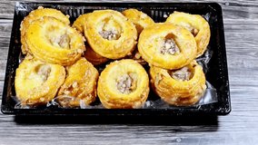 Danish pastry, a sweet, multilayered, flaky pastry made from a laminated, yeast-leavened dough with a high butter content, soaked with sweet honey syrup, filled with cinnamon, raisin and pineapple - Powered by Shutterstock - Get 15% off with code: PIKWIZARD15
