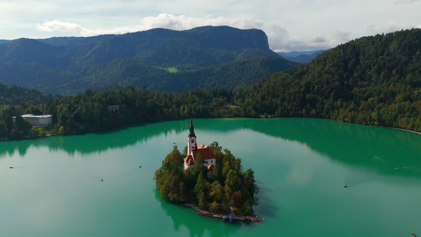 Aerial drone fly Slovenian Bled Island, pristine turquoise lake with Church of the Assumption of St. Mary