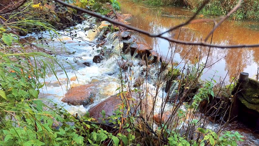 churning, foamy water on a river rapid on a bright summer day