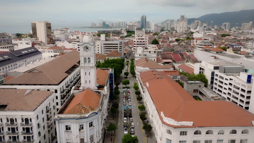 Drone footage of George Town’s historic center in Penang, Malaysia, showing colonial architecture, city skyline, and urban traffic from above.