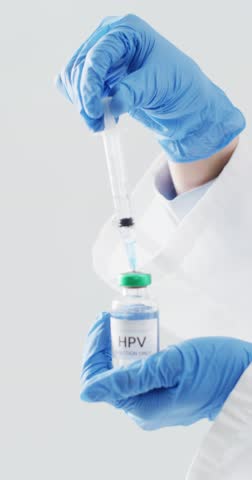 Vertical video of hands of caucasian doctor preparing hpv vaccination, with copy space. Health awareness, std, medical care, support and healthcare services concept.