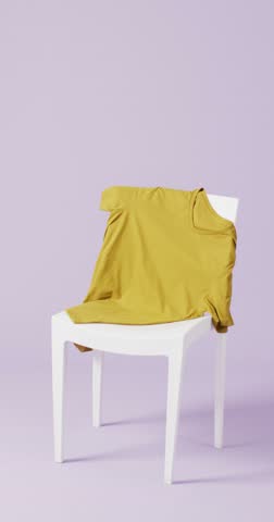 Vertical video of close up of mustard t shirt on white chair and purple background with copy space. Clothing, fabric, texture and materials concept.