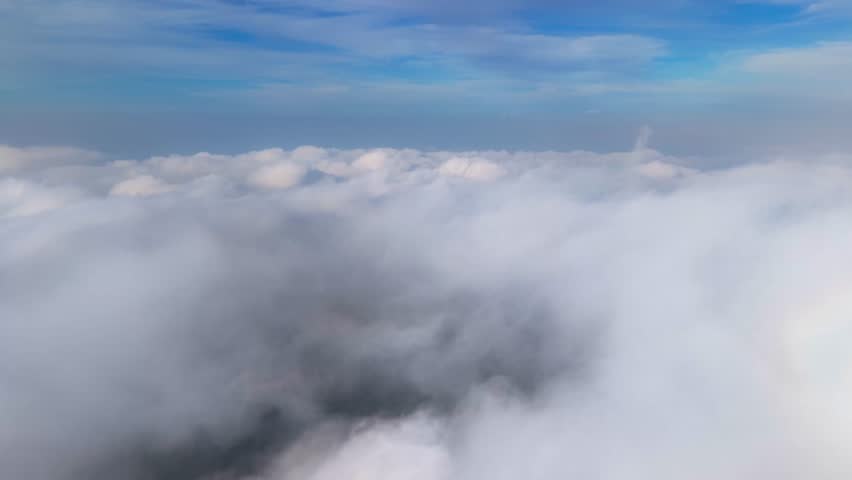 Aerial view of a blanket of white clouds, soft and billowy, against a backdrop of blue sky, Kaliurang, Daerah Istimewa Yogyakarta, Indonesia.
