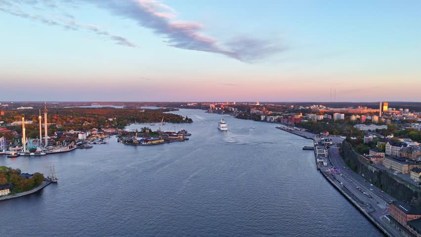 Aerial view of Fjallgatan and a cruise ship sailing through the tranquil waters under a pastel sky, Stockholm, Stockholms lan, Sweden.