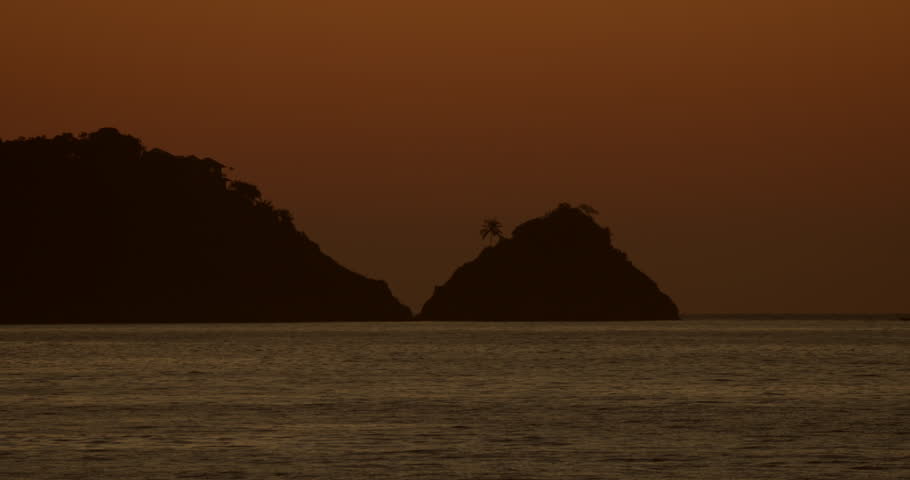 Colorful sunset or sunrise sky with small island