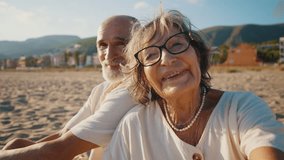 Affectionate elderly couple enjoying a romantic moment together during a picnic on a sandy beach at sunset, showing love, tenderness, and a happy retirement lifestyle by the sea - Powered by Shutterstock - Get 15% off with code: PIKWIZARD15