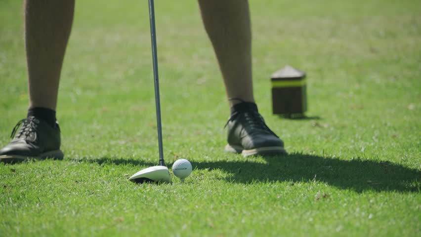 Nottingham, UK, 12-05-2025: Person teeing off from a tee box with a driver on Wollaton Hall golf course, Nottingham.