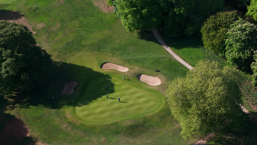 Nottingham, UK, 12-05-2025: Aerial views of people playing golf at Wollaton Park Golf Course on the grounds of Wollaton Hall and Deer Park in Nottingham.
