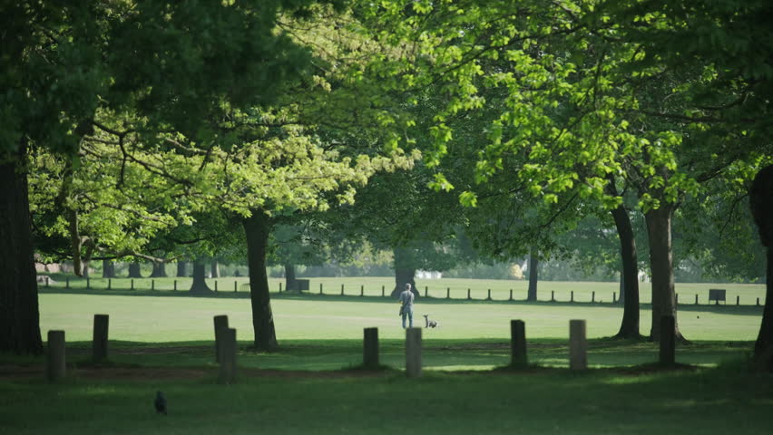 Nottingham, UK, 09-05-2025: Person walking through Wollaton Hall Park, Nottingham.
