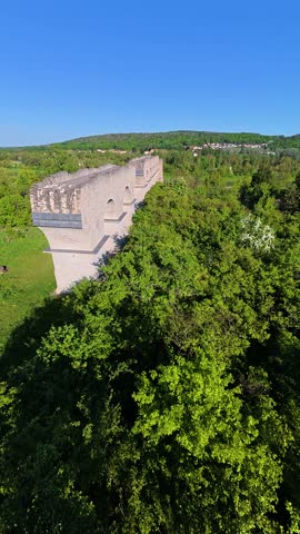 Cinematic FPV drone footage capturing a fast flyover of an ancient Roman aqueduct surrounded by natural scenery. Perfect for historical documentaries, travel videos, and cinematic projects.