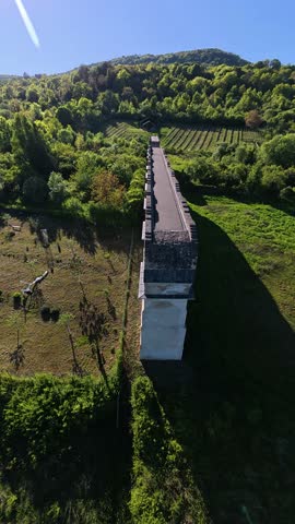 Cinematic FPV drone footage capturing a fast flyover of an ancient Roman aqueduct surrounded by natural scenery. Perfect for historical documentaries, travel videos, and cinematic projects.