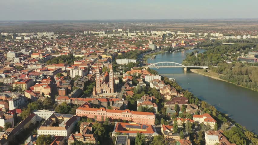 Aerial view of Szeged Hungary featuring the Tisza River and cityscape on a sunny day