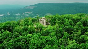 An ancient castle stands majestically in the heart of a misty, sun-dappled forest. This fairytale scene blends nature's serene beauty with historic grandeur. - Powered by Shutterstock - Get 15% off with code: PIKWIZARD15