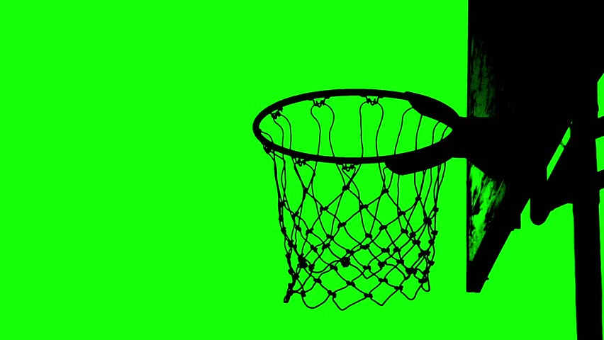 Silhouette of a basketball going through a hoop, captured against a vibrant green backdrop. The stark contrast between the black and green creates a visually striking image
