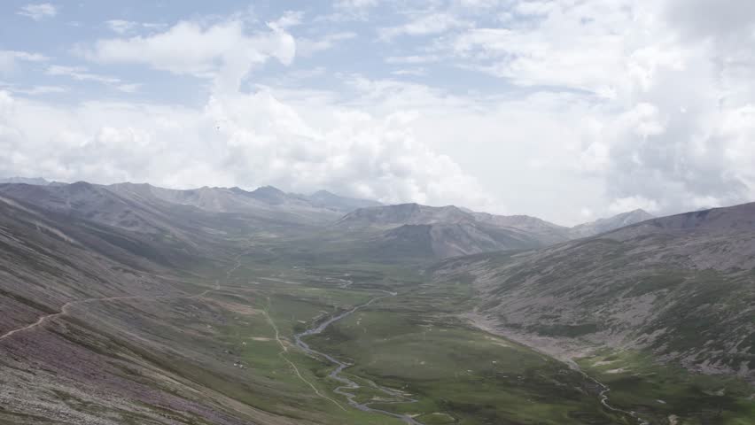 Expansive green valley seen from Babusar Top, with winding streams and distant peaks. Khyber Pakhtunkhwa, Pakistan
